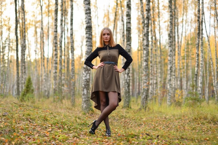 Woman Standing in Autumn Forest with Stylish Dress