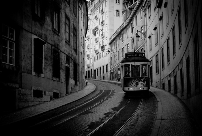 Monochrome image of a tram on a city street