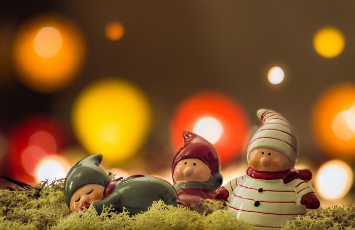 Christmas gnomes on moss with bokeh lights
