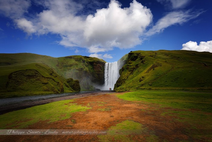Skogafoss Waterfall in Iceland with two people