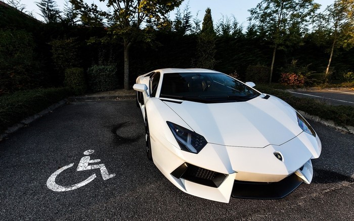 White Lamborghini Aventador parked in a disabled spot