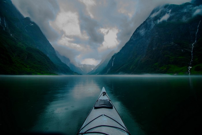 Kayaking through a misty fjord in Norway
