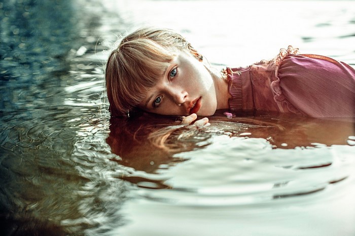 Young woman lying in water