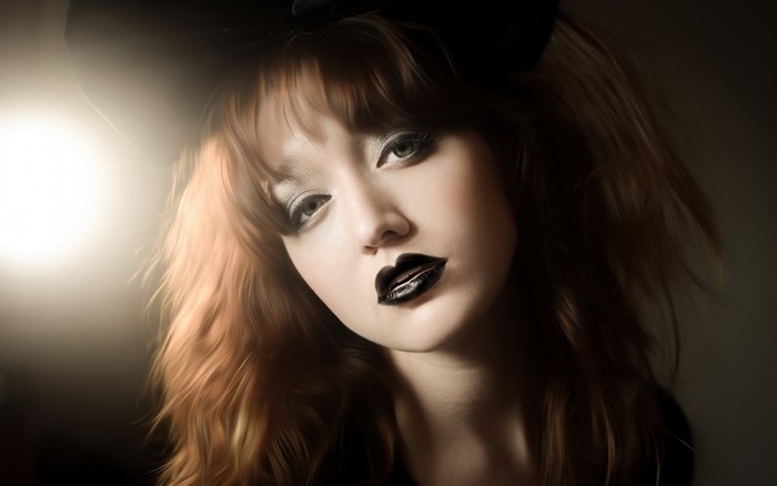 Woman with dark lipstick and dramatic makeup
