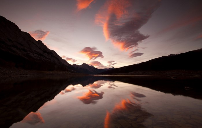 Sunset clouds reflected in a mountain lake
