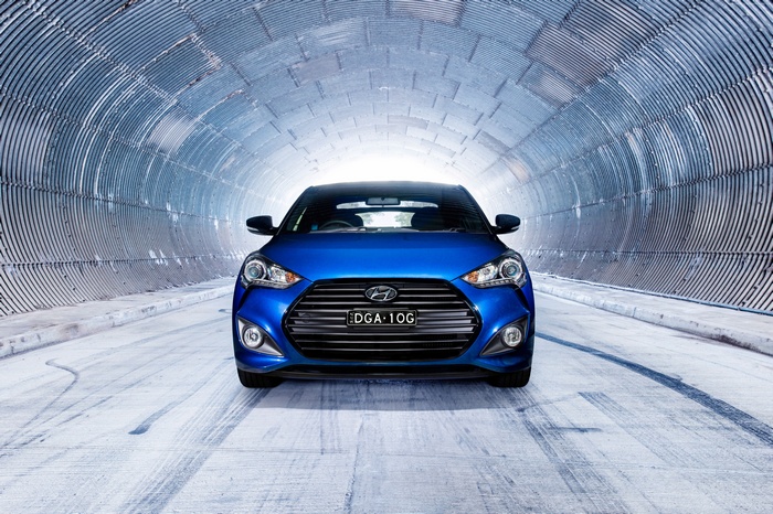 Blue Hyundai Veloster in a tunnel