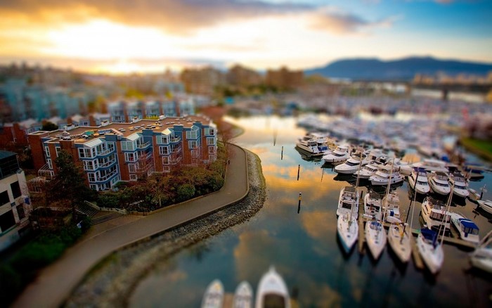 Apartment buildings and boats in a marina at sunset