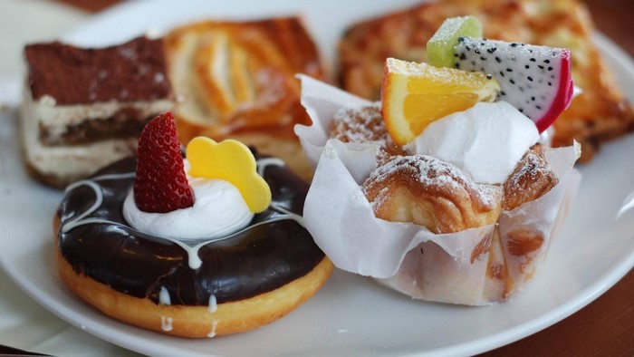 Assortment of pastries including a donut and fruit tart