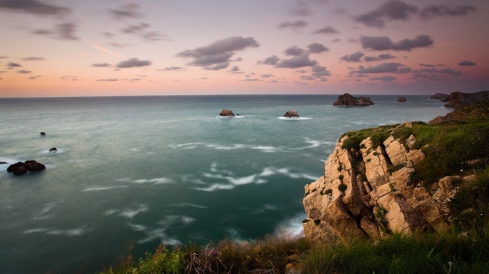 Ocean cliffs at sunset with rock formations