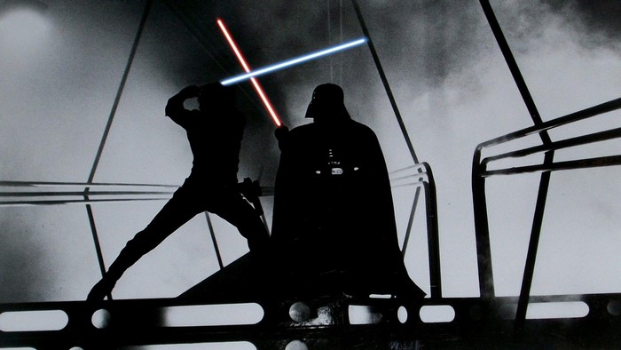 Luke Skywalker and Darth Vader duel with lightsabers