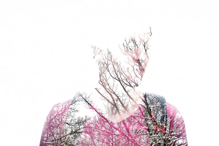 Double exposure of a person and trees