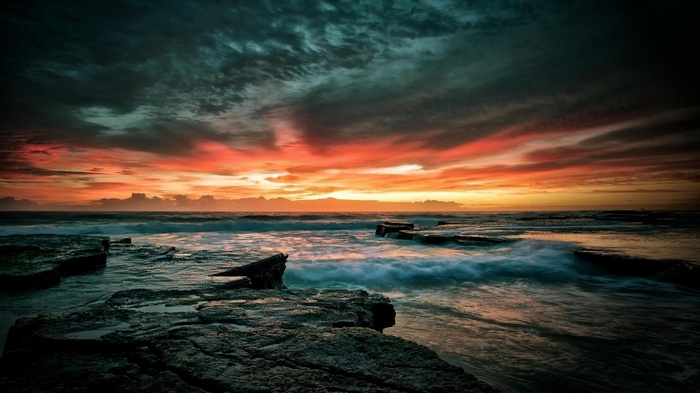 Dramatic Sunset Over Rocky Coastline