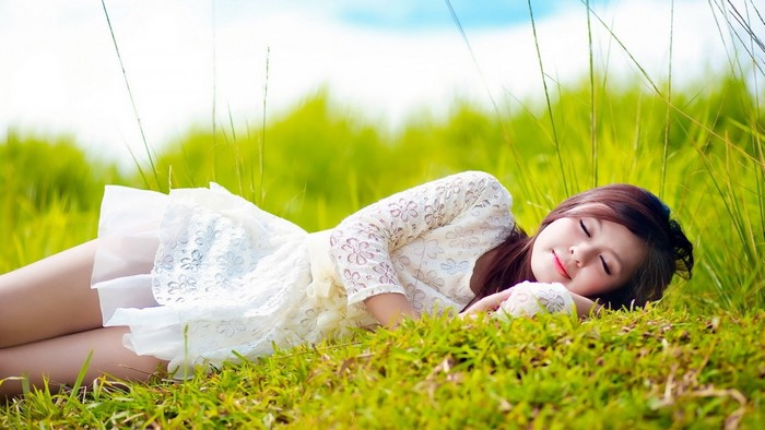 Peaceful Woman Resting in Green Meadow