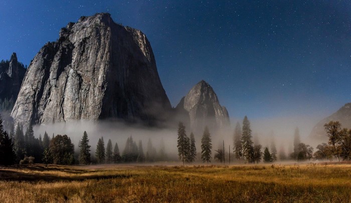 Mountain peaks shrouded in mist at night
