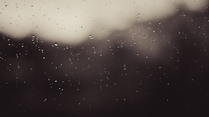 Raindrops on a window at night