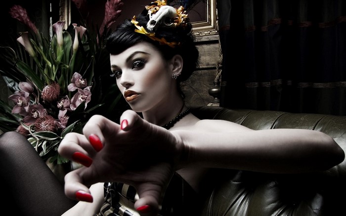 Woman with dramatic makeup and skull headdress