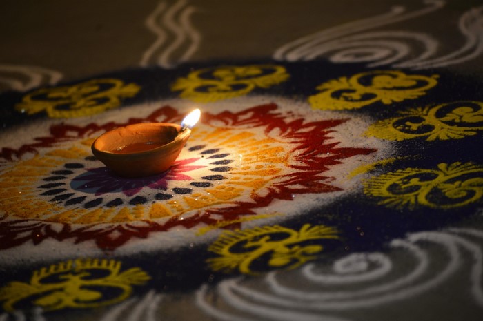 Diwali lamp on a colorful rangoli