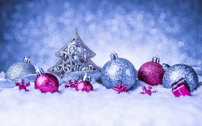 Christmas ornaments and tree in snow