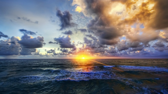 Sunset over the ocean with dramatic clouds