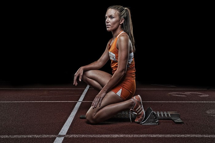 Female athlete in starting blocks on a track