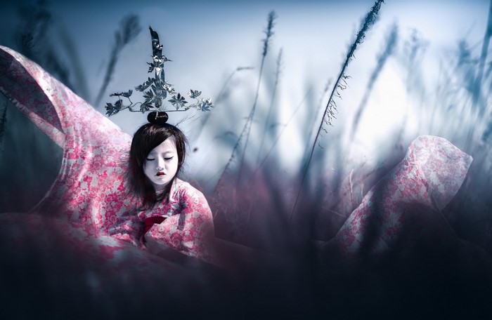 Young Asian woman in traditional attire with ornate headpiece