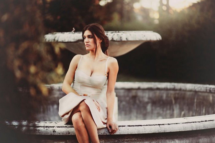 Woman sitting by a fountain