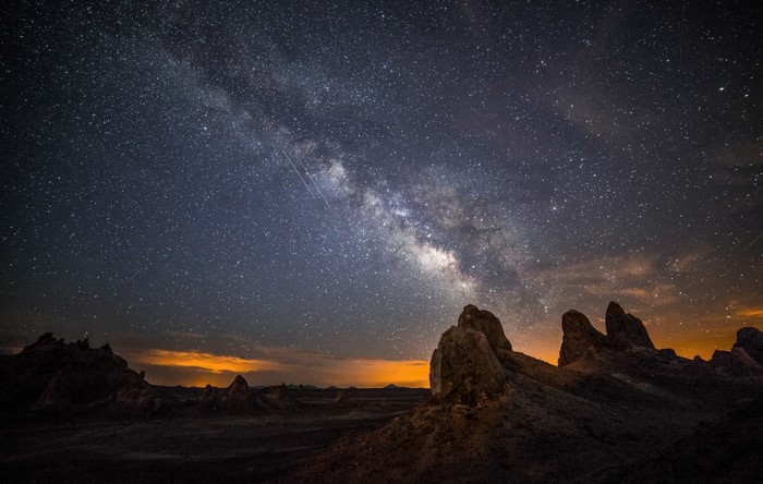 Milky Way galaxy over desert rock formations at night