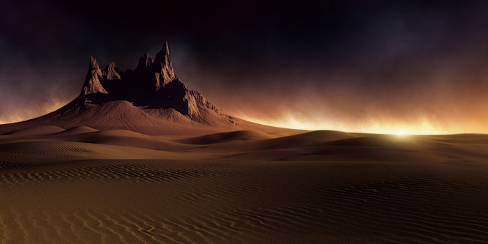 Desert landscape with mountains at sunset