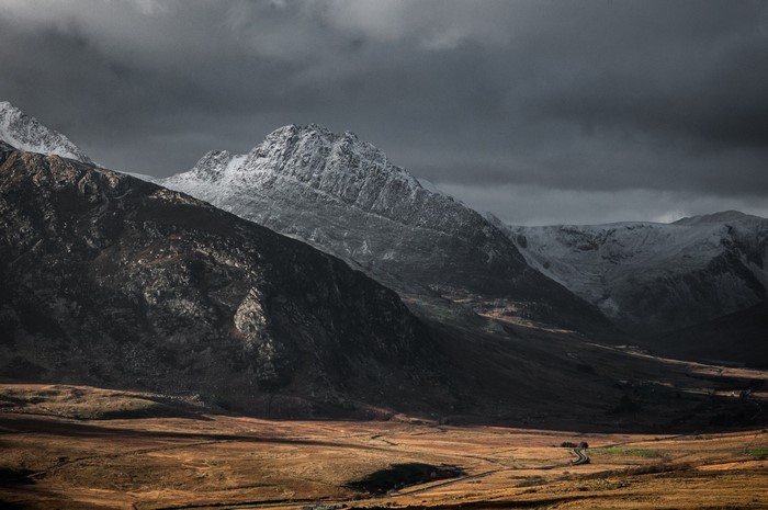 Snow-capped mountains under a cloudy sky