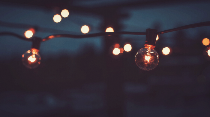 String of glowing lightbulbs at night