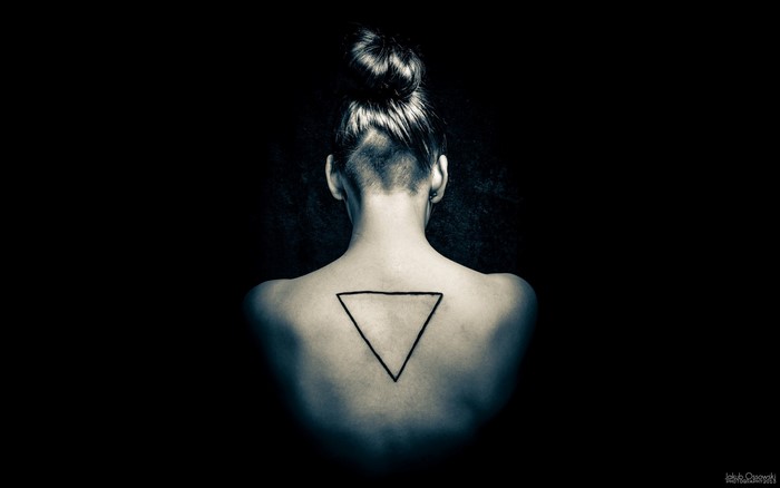 Woman with triangle tattoo on back