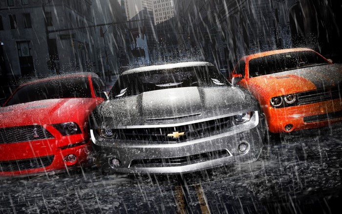 Three muscle cars in the rain