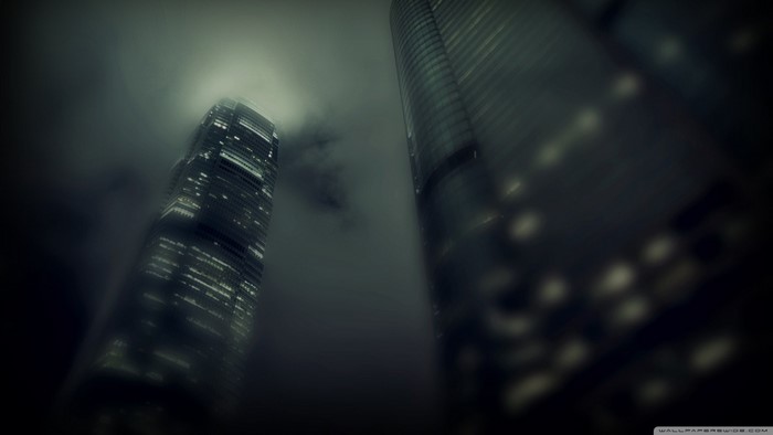 Skyscrapers shrouded in mist at night