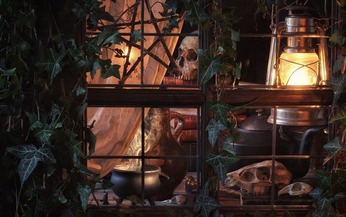 Halloween window with skulls and cauldron