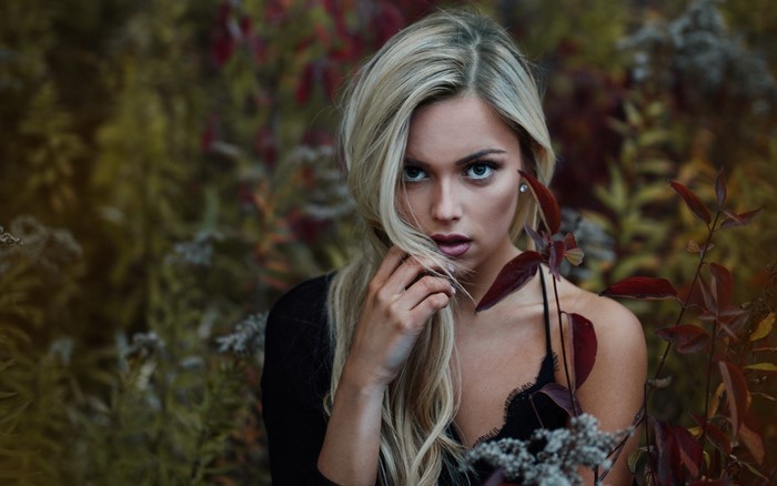 Woman with blonde hair in a forest setting
