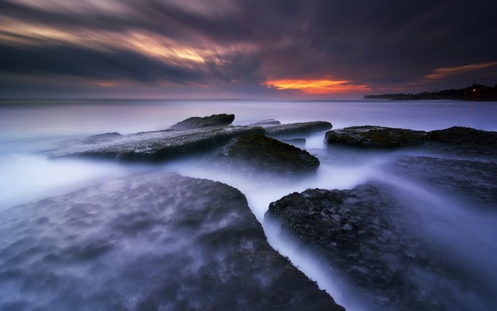 Long exposure of rocks and sea at sunset