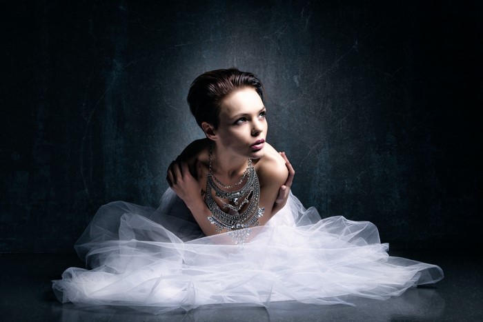 Woman in white dress and necklace