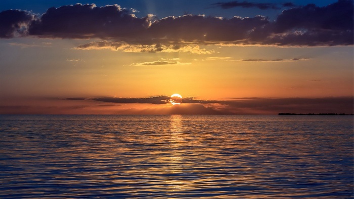 Sunset over the ocean with clouds