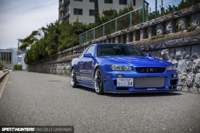 Blue Nissan Skyline R34 GT-R parked on a street