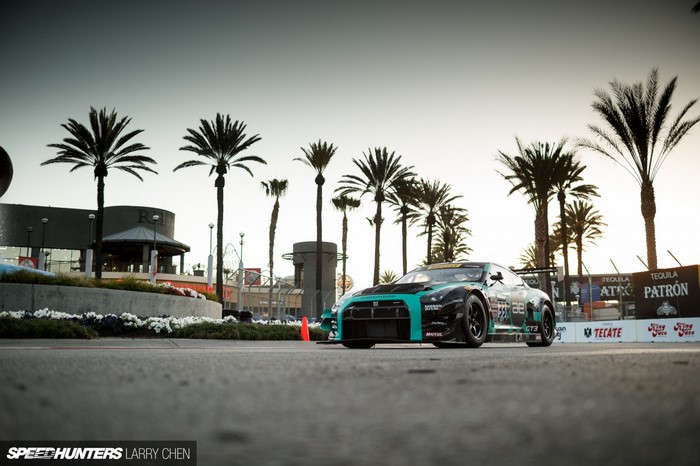 Nissan GT-R race car with palm trees and banners