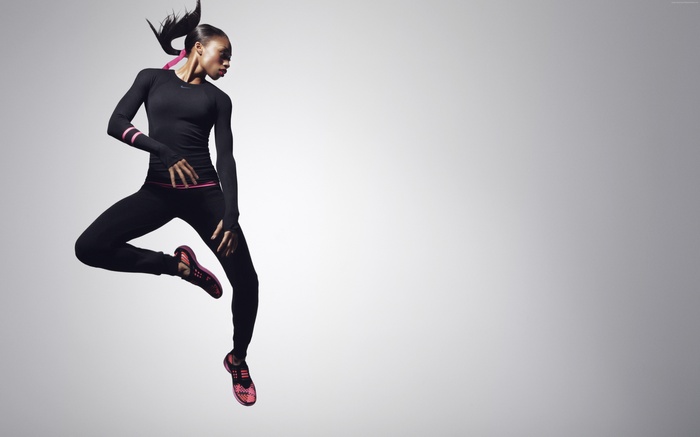 Allyson Felix in Nike athletic wear jumping