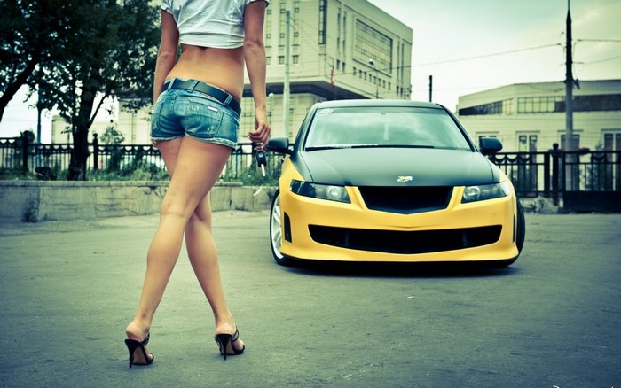 Woman in denim shorts and yellow car
