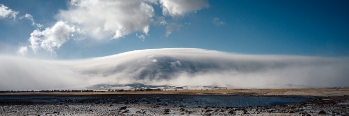 Lenticular cloud over a snowy landscape