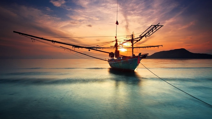 Fishing boat at sunset on the ocean