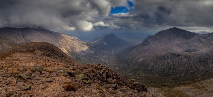 Panoramic view of a mountain valley with dramatic clouds