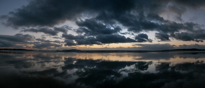 Stormy sunset over the sea with reflections