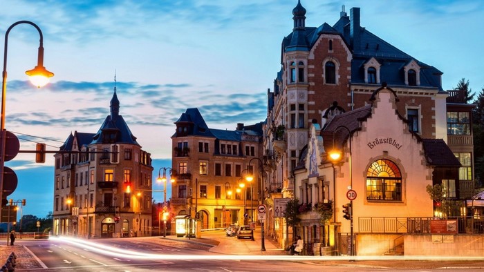 Street view of buildings and streetlights in Germany at dusk