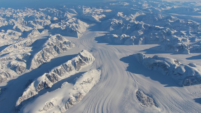 Aerial view of snow-covered mountains and glaciers in Greenland