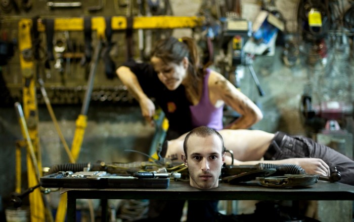 Woman working on a robot in a workshop