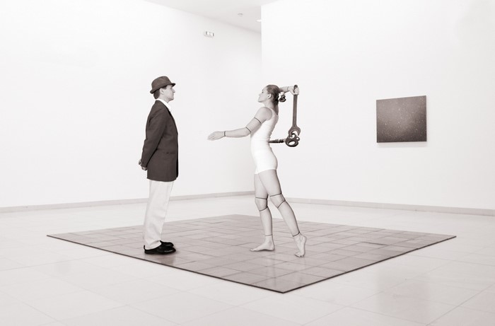 Mannequin holding a wrench in an art gallery